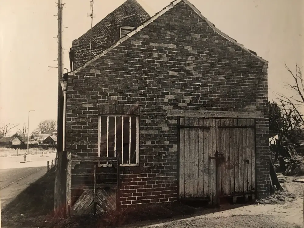 The old brick outbuilding with wooden doors