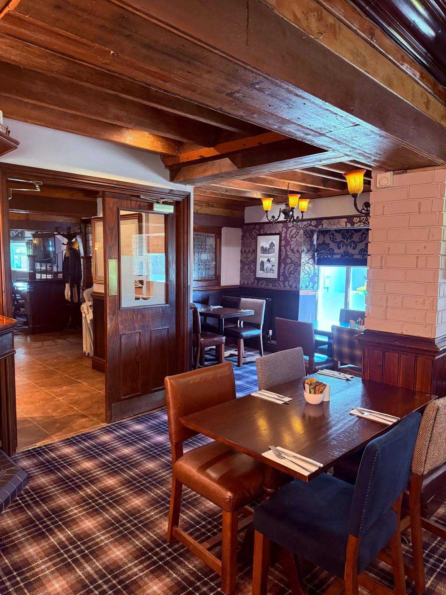 The restaurant interior with exposed beams and wooden tables