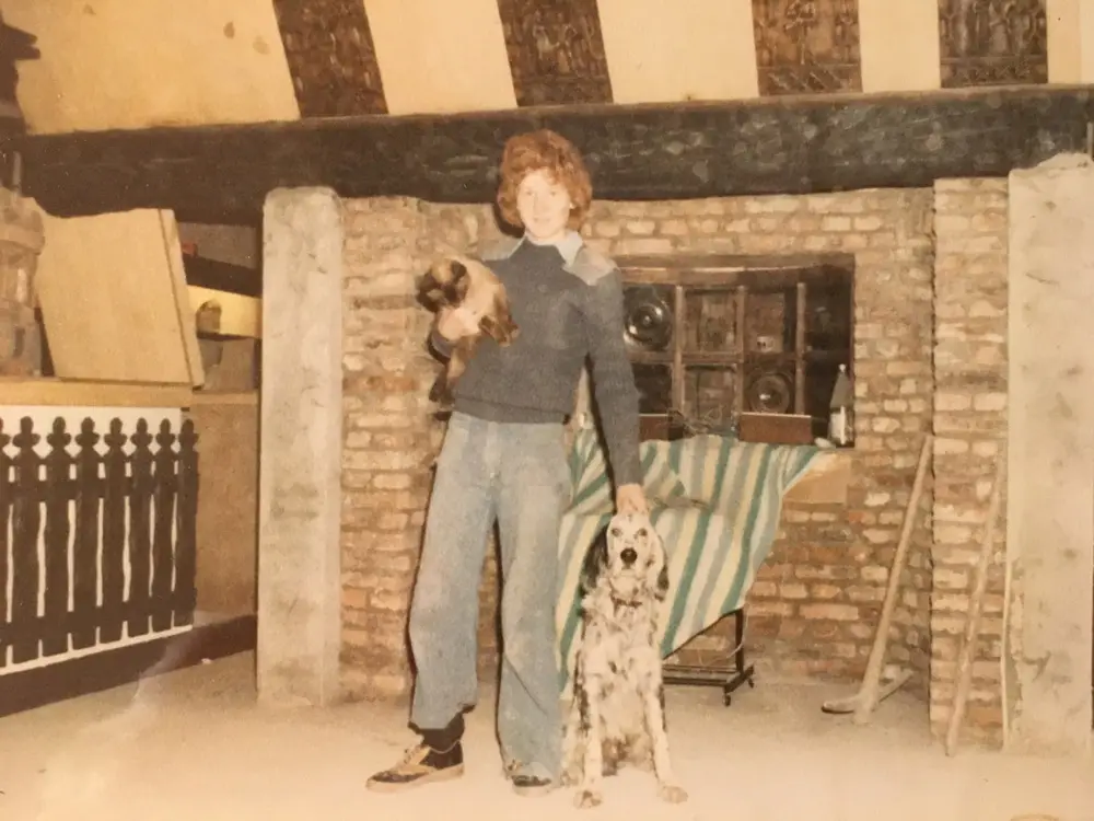 Family and dogs by the fireplace in the early days